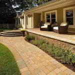 This porch was originally concrete.  We overlaid it with pavers, and added a new paver walkway and step.
